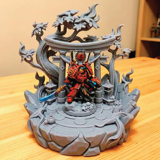 Decorative figurine of a samurai warrior in a detailed architectural setting on a wooden surface.