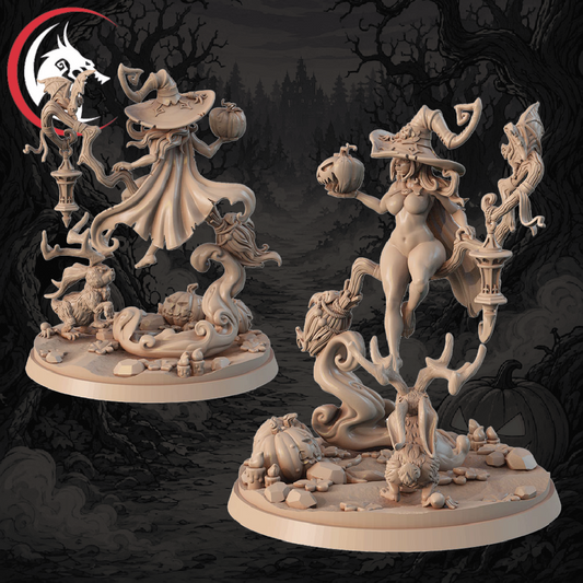 Two unpainted fantasy tabletop miniatures of nude female witches with wide-brimmed hats, standing on detailed gothic bases with pumpkins, skulls, and skeletal figures, shown against a dark spooky forest background. A wolf-head logo is visible in the top-left corner.