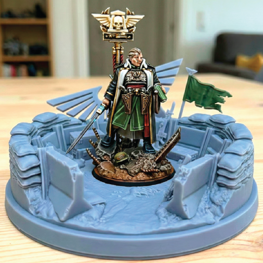 Warhammer figurine on a blue base with a detailed landscape