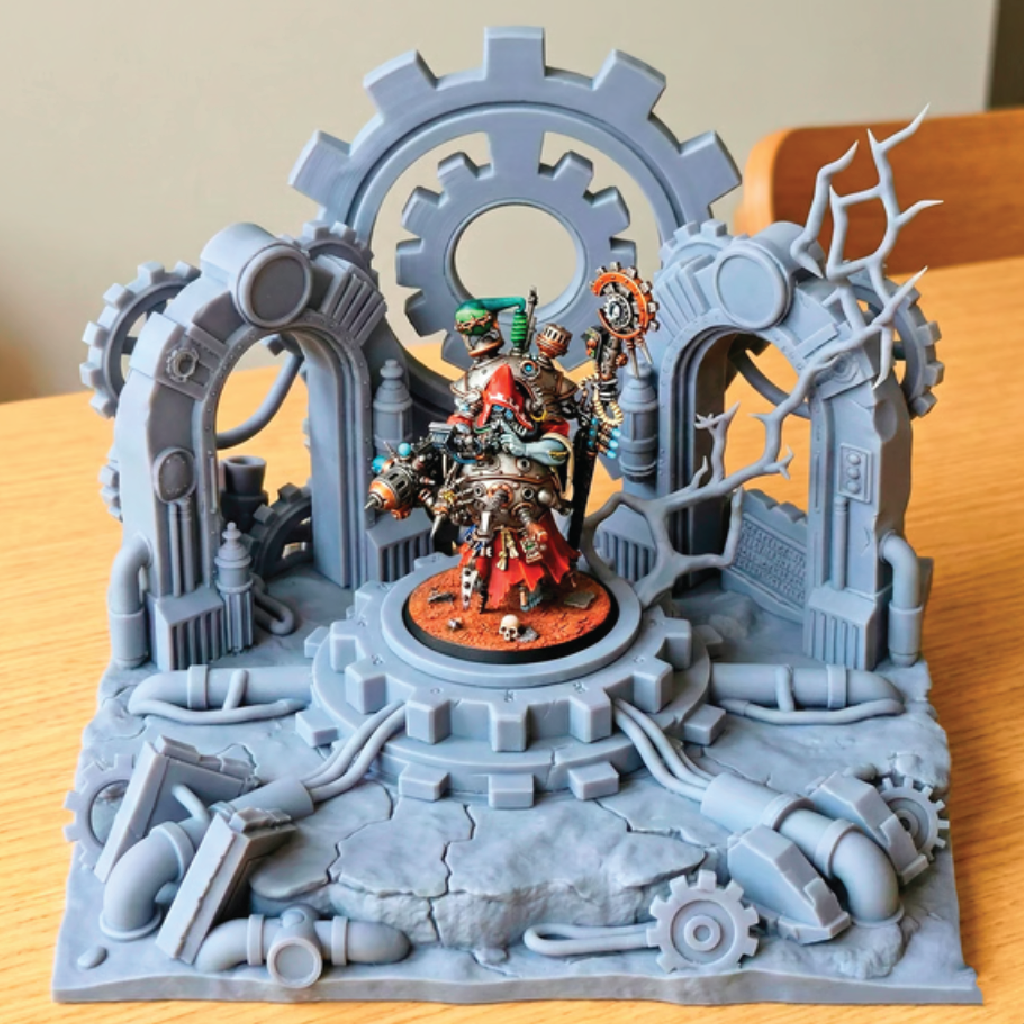 Detailed model with mechanical elements and a central figure on a wooden surface