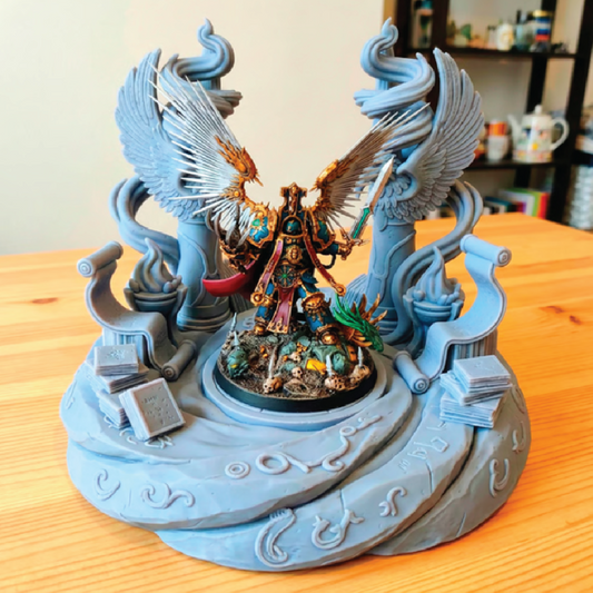 Detailed figurine with wings on a decorative stand on a wooden surface