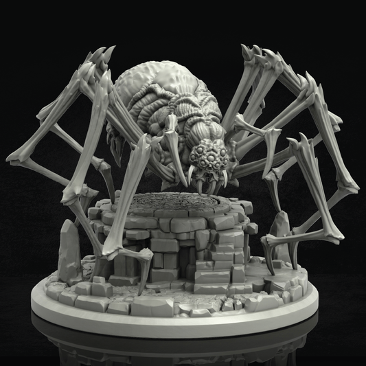 A gray 3D-printed unpainted miniature of a monstrous spider-like creature with large bone-like legs and a skull-like head, standing over a ruined stone pedestal on a circular base against a black background.