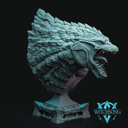 A detailed fantasy bust sculpture of a dragon head on a pedestal, rendered in a textured teal-gray finish against a black background, with a Witchsong logo in the bottom right corner.