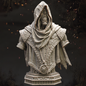 Statue of a hooded figure with intricate details on a dark background