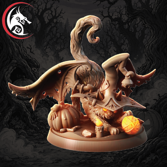A fantasy miniature figurine of a horned dragon-like creature posed over a pumpkin and candle, with a glowing orange orb, on a round base. The background is a dark, spooky forest scene.