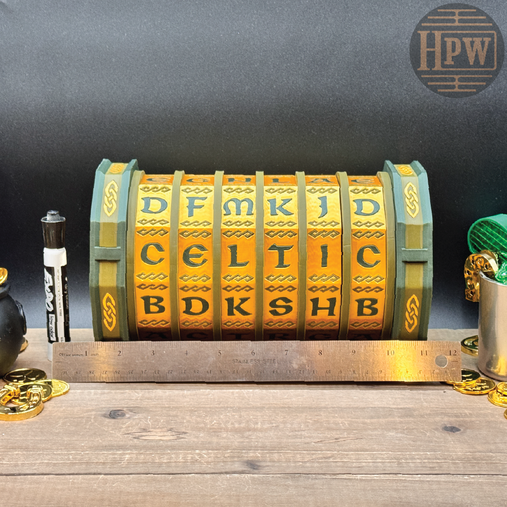 Decorative Celtic wheel with letters on a wooden surface, ruler, and coins.