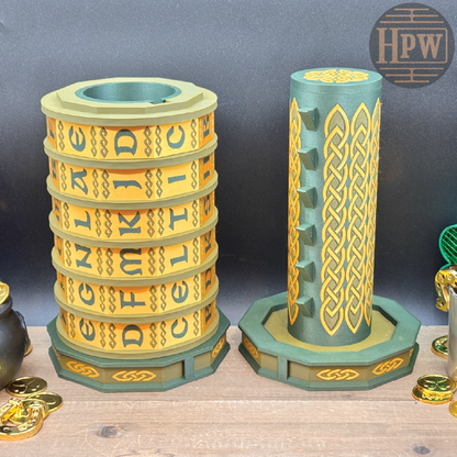 Stack of interlocking rings with Celtic knot design on a wooden surface, featuring the brand 'HPW'.