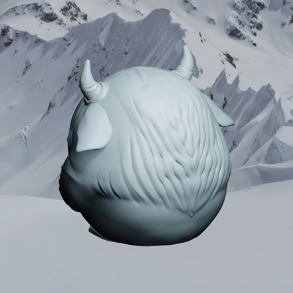 Snow sculpture of a creature with horns against a snowy mountain background