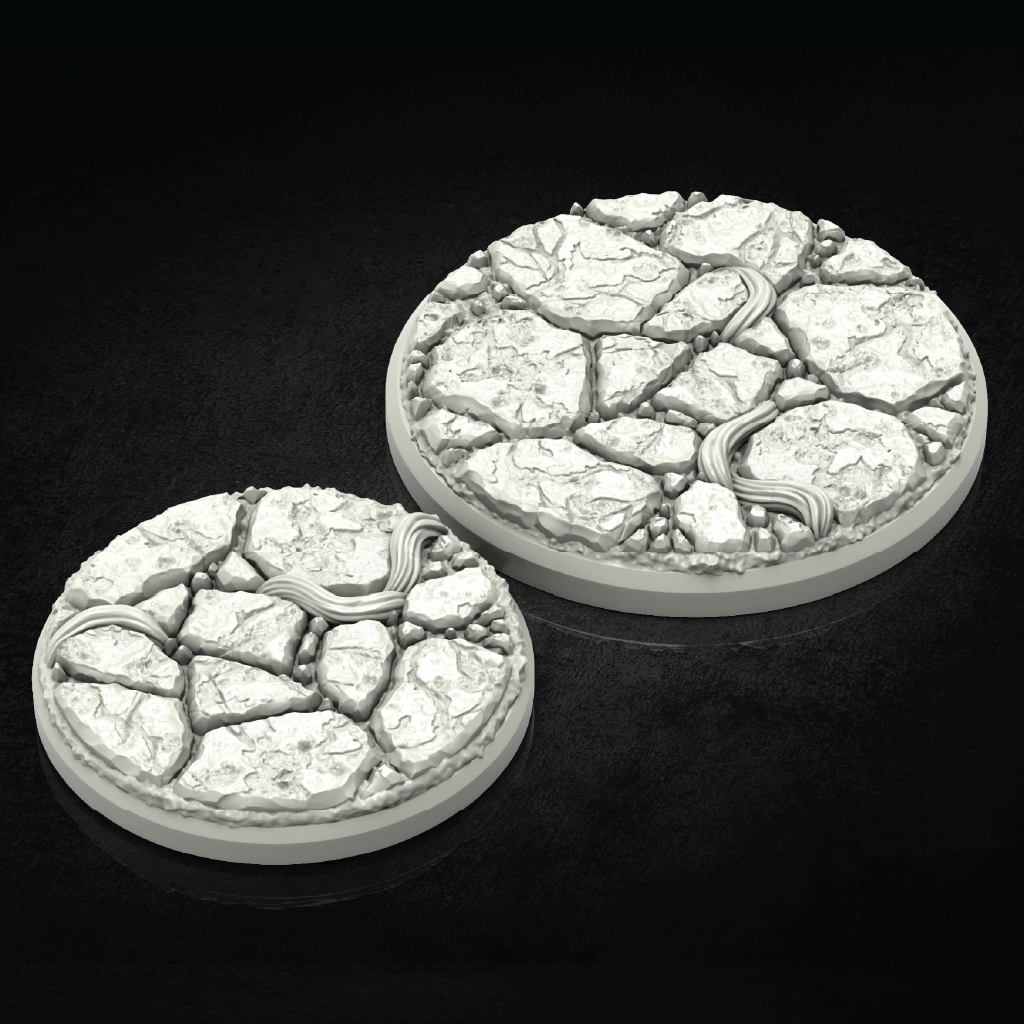 Two round 3D-printed terrain bases with a cracked stone texture and a winding river detail, shown on a dark reflective background.