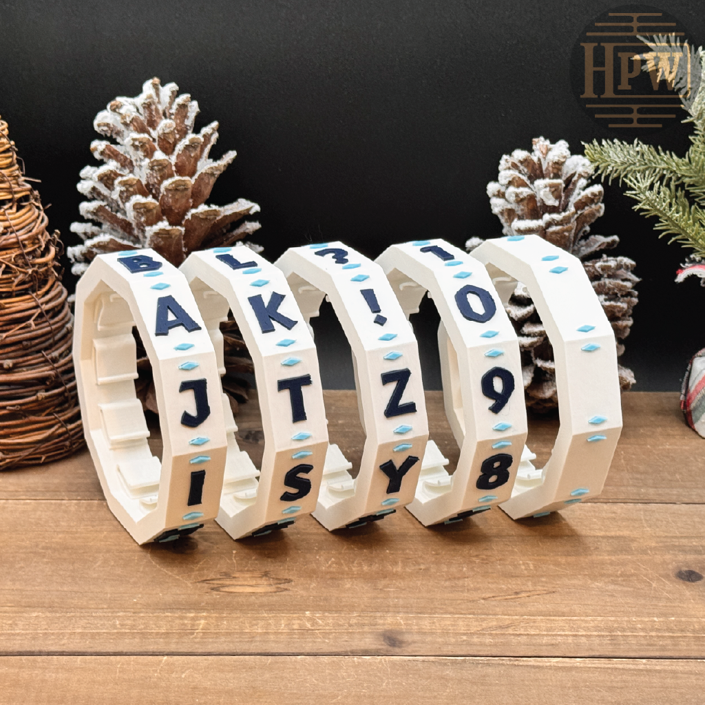 Decorative puzzle box with letter patterns on a wooden surface