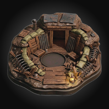 A highly detailed miniature diorama of a circular trench or fort, featuring weathered brown wood, olive green sandbags, and a small glowing lantern, set against a dark gradient background.