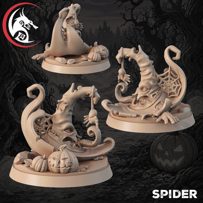 Three unpainted fantasy tabletop miniatures shaped like spider-themed witch hats and spider-themed moon bases, shown on a dark spooky forest background. The logo in the top-left reads 'The Dragon' and the text 'SPIDER' appears in the bottom-right.