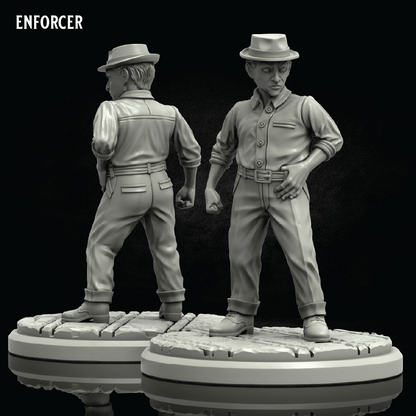 Two unpainted miniature figurines of a man in a hat and work shirt, shown from front and back views on circular bases against a black background, with the brand name ENFORCER in the top left corner.