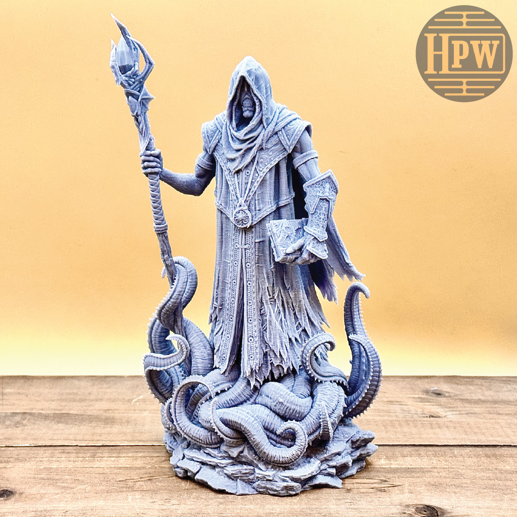 Statue of a hooded figure with a staff on a wooden surface, branded 'HPW'.