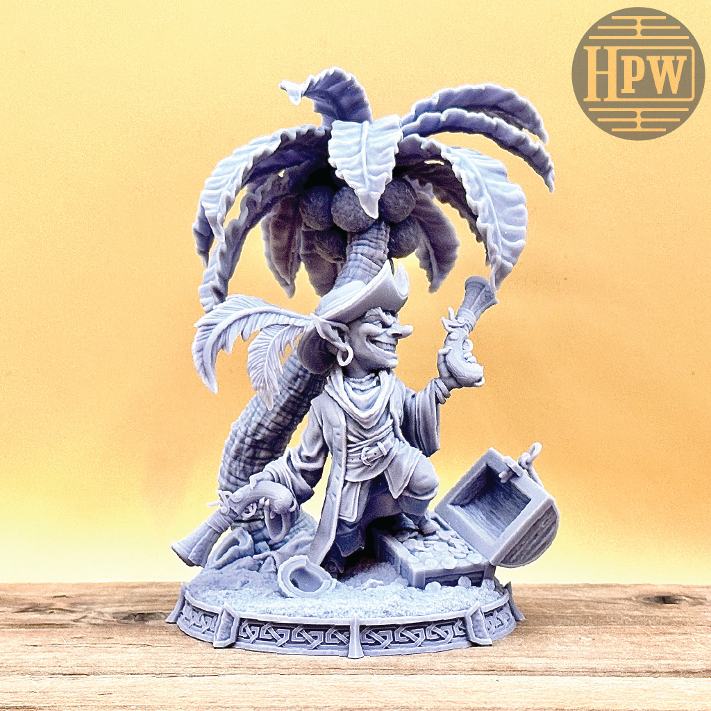 A goblin pirate wielding miniature blunderbusses standing under a palm tree and on top of an open treasure chest full of coins. This is a model 3D printed in gray UV resin.