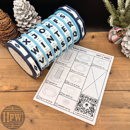 Decorative puzzle box with letter patterns on a wooden surface