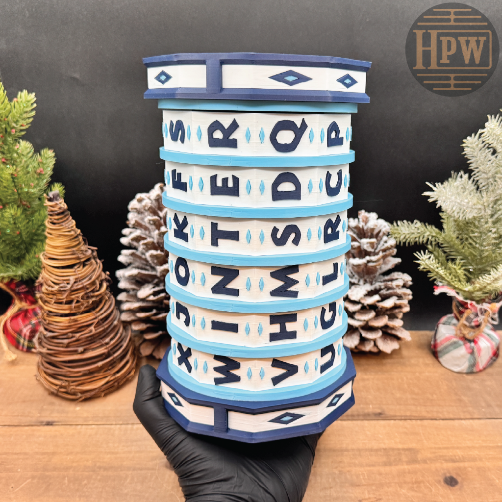 Decorative puzzle box with letter patterns on a wooden surface