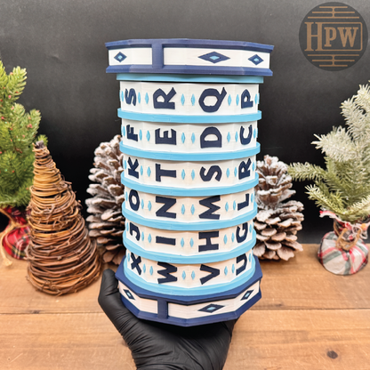 Decorative puzzle box with letter patterns on a wooden surface