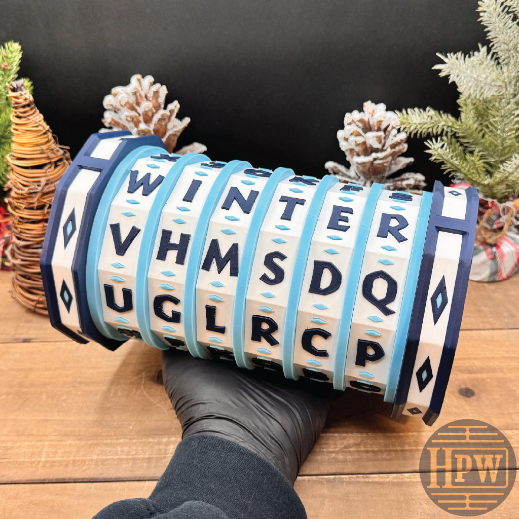 Decorative puzzle box with letter patterns on a wooden surface