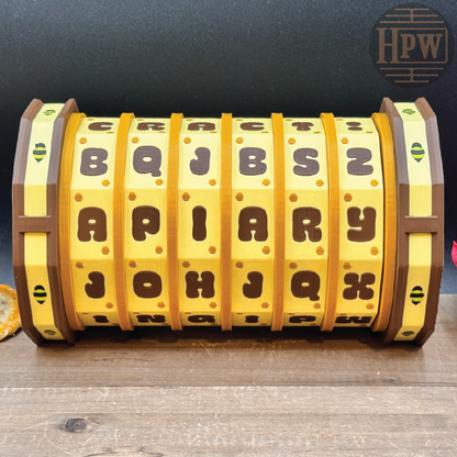 Cipher wheel with lettered bands on a wooden surface, branded 'HPW'.