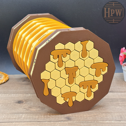 Set of honeycomb-themed coasters with a wooden holder on a wooden surface.