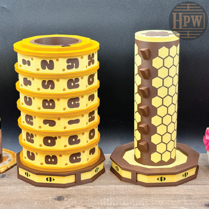 Two honeycomb-shaped toys on a wooden surface with a dark background