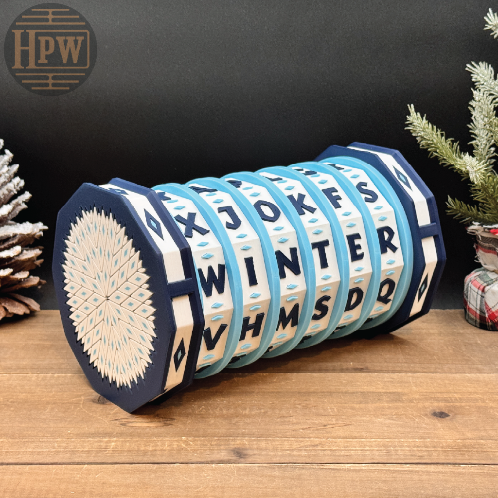 Decorative puzzle box with letter patterns on a wooden surface