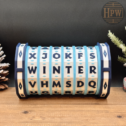 Decorative puzzle box with letter patterns on a wooden surface