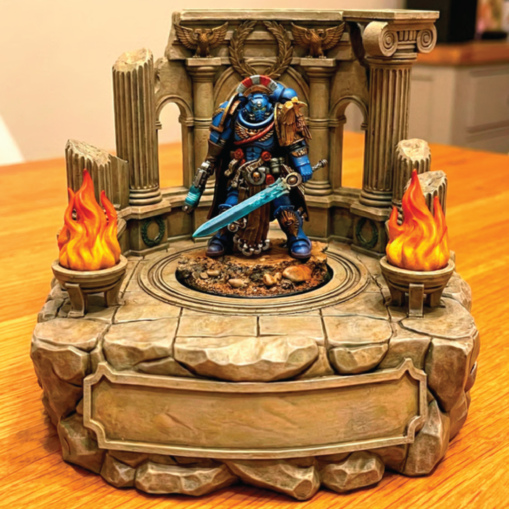 Fantasy figurine with a sword on a decorative stone platform with flames.