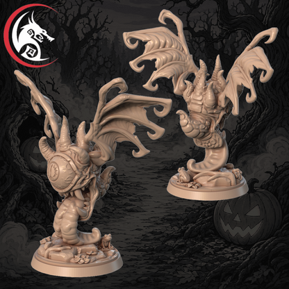 An unpainted fantasy miniature figurine shown from two angles against a dark illustrated Halloween background. The product appears to be a beige/tan dragon or winged creature on a round base, with horns, wings, and a small base detail.