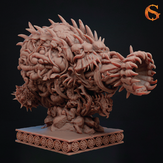 A highly detailed fantasy sculpture of a monstrous creature with a gaping mouth, sharp teeth, and a spiked shell-like body, mounted on a decorative wheeled base against a dark background. An orange stylized 'G' logo appears in the top right corner.