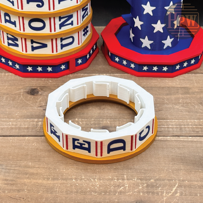 A patriotic-themed octagonal cookie cutter in the foreground, with matching patriotic cookie cutters stacked in the background on a wooden tabletop.