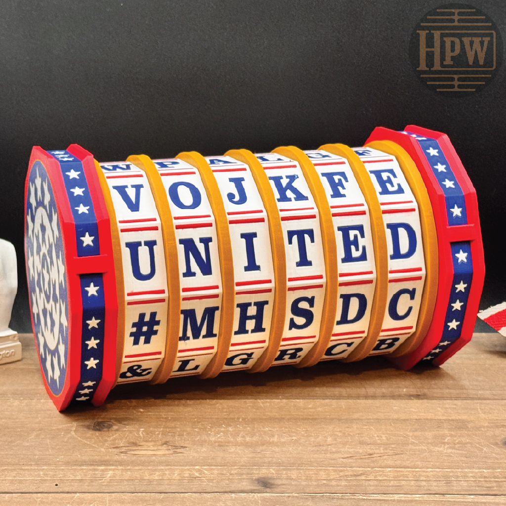 A patriotic-themed rotating alphabet light sign spelling out 'UNITED' with red, white, and blue segments, displayed on a wooden surface against a dark background.