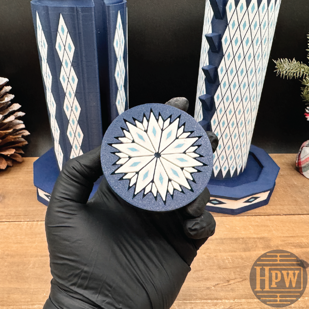 Decorative puzzle box with letter patterns on a wooden surface