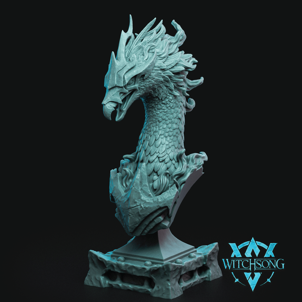 A detailed fantasy bust sculpture of a dragon head on a pedestal base, shown in a light teal-blue color against a solid black background. A 'WITCHSONG' brand logo is visible in the bottom right corner.