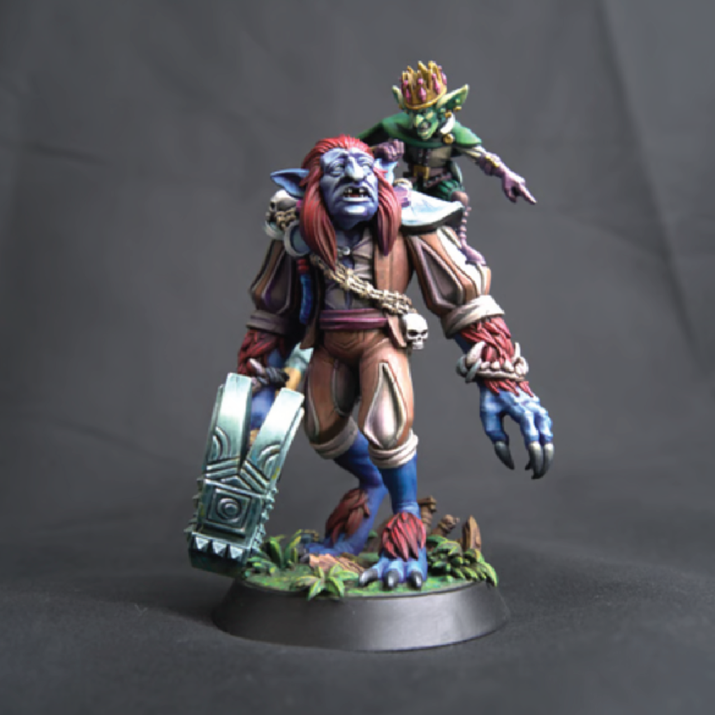 Colorful fantasy figurine with a character on its back against a dark background
