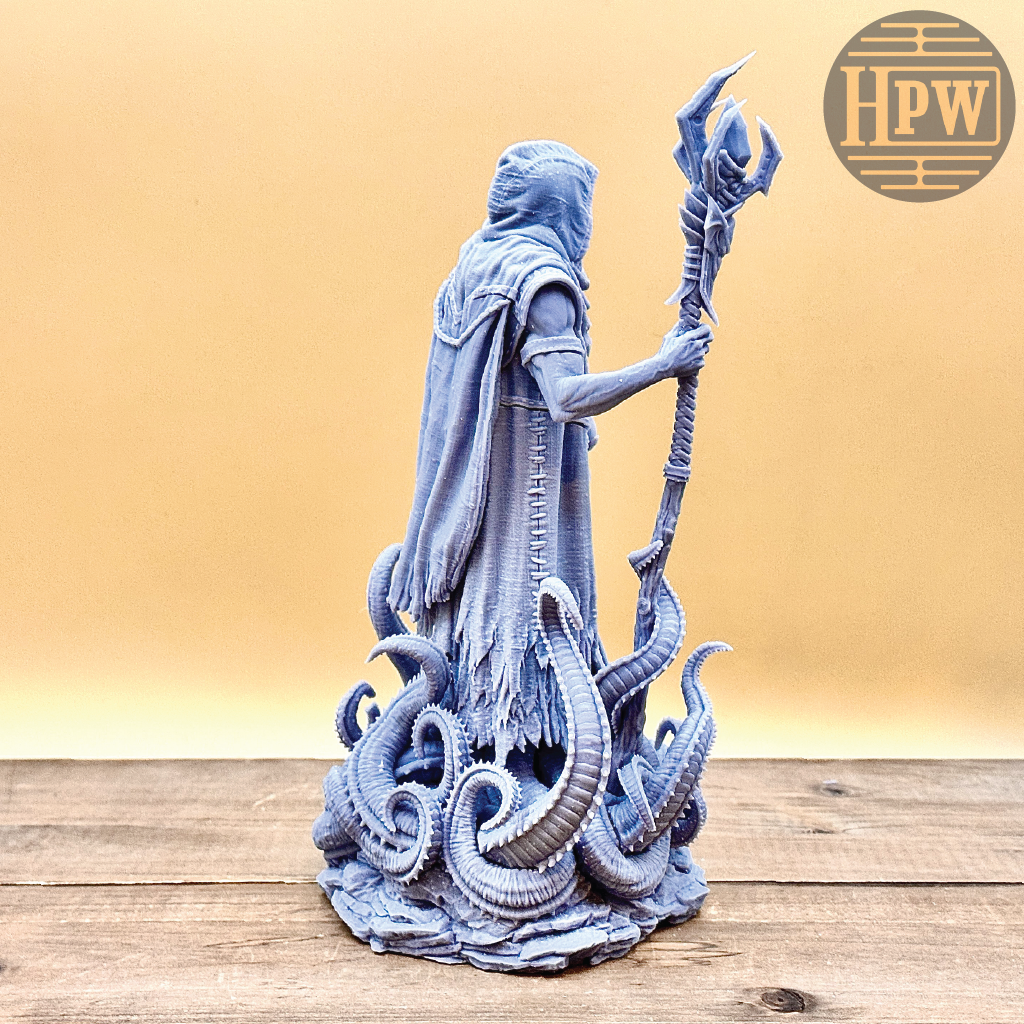 Statue of a figure with tentacles and a staff on a wooden surface, with 'HPW' logo in the corner.
