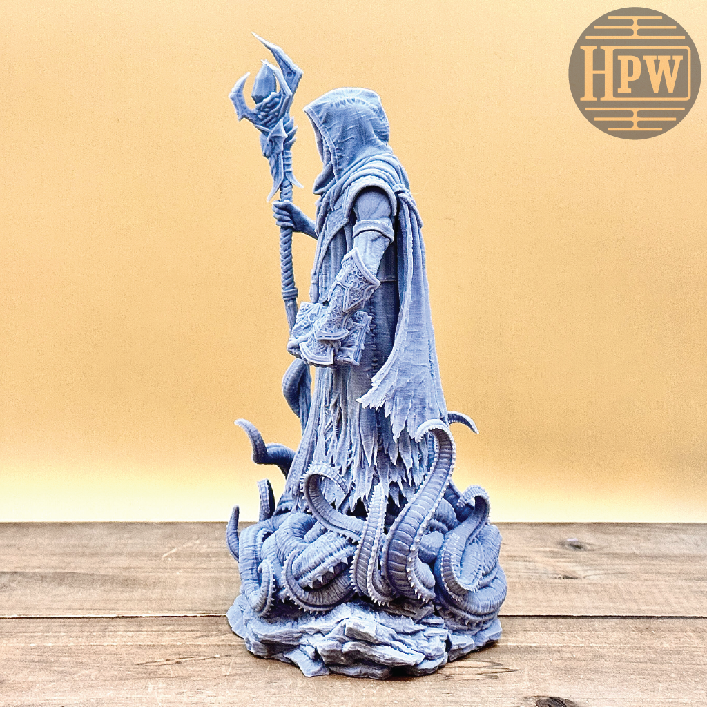 Statue of a warrior with a staff and serpents on a wooden surface, branded 'HPW'.