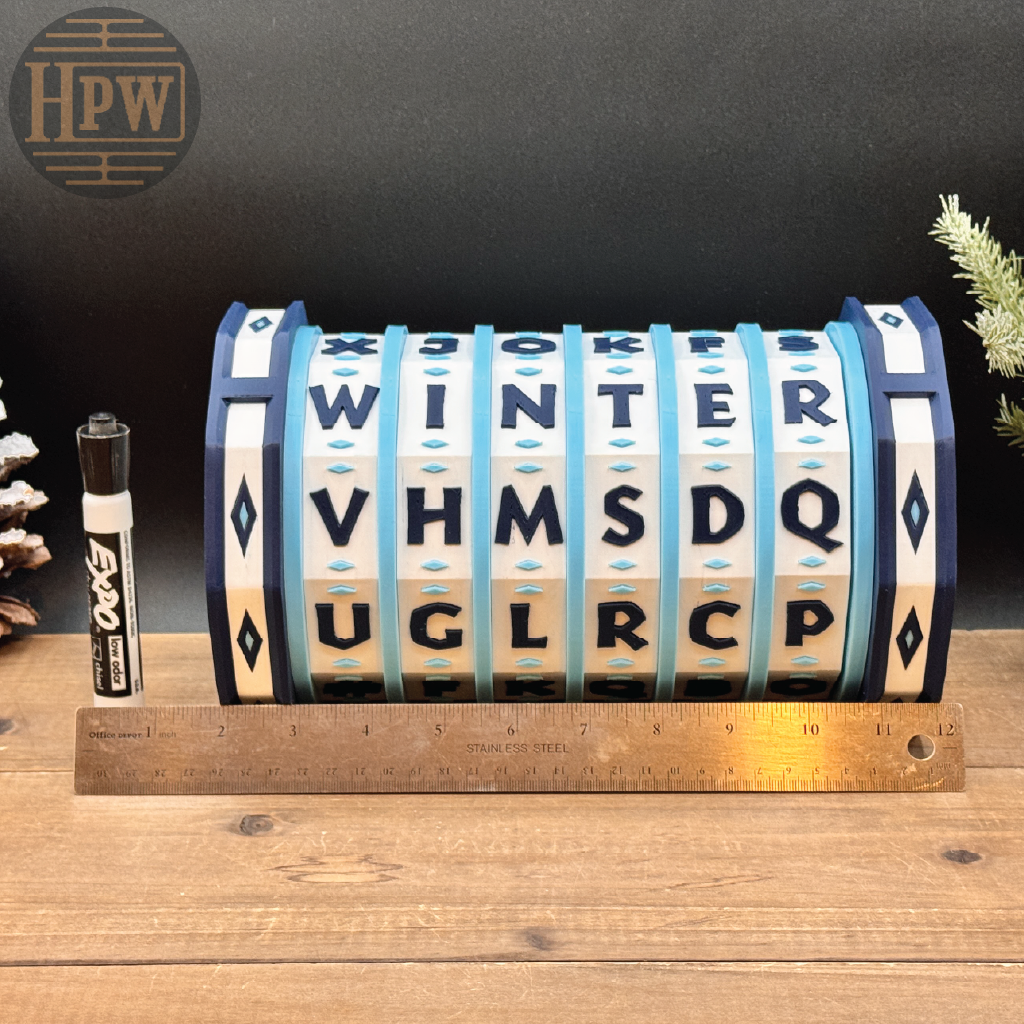 Lettered cylindrical object with a marker and ruler on a wooden surface, branded 'HPW'.