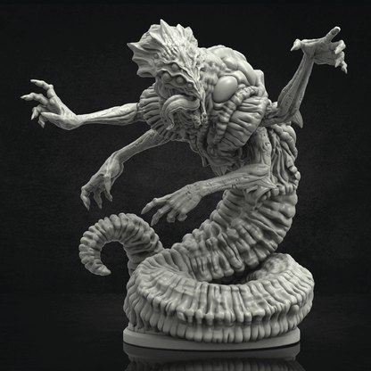 Monster figurine with snake-like body and humanoid head on a black background