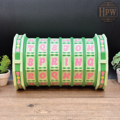 Green and pink toy tunnel with text on a wooden surface and black background