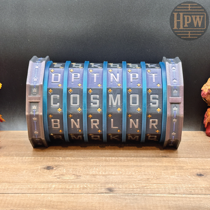 A cylindrical, multi-letter rotating lock or combination device with blue and gray segments, resting on a wooden surface against a dark background.