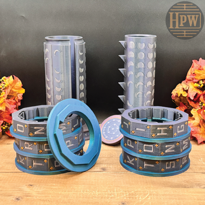 Three sets of 3D-printed letter O ring molds in blue, gray, and silver, displayed on a wooden surface with autumn leaves against a dark gray background. An HPW logo is visible in the top right corner.