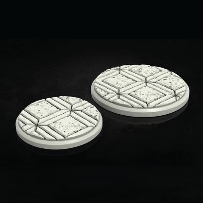 Two round, textured game bases on a black background