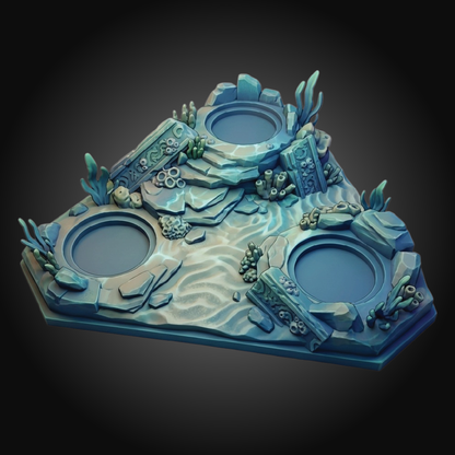 A 3D-printed miniature undersea-themed tabletop terrain piece featuring three circular water pools surrounded by rocky coral structures and sea plants in shades of blue and teal.