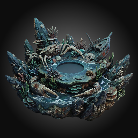 An underwater-themed decorative sculpture or planter featuring a miniature shipwreck, coral formations, sea creatures, and a central dark pool, shown against a dark gradient background.