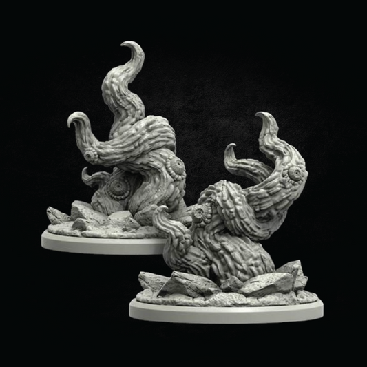 Two unpainted gray fantasy miniature terrain pieces shaped like twisted tree roots or gnarled rock formations, each mounted on a round base, shown against a black background.