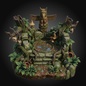 A detailed fantasy miniature base depicting an ancient, moss-covered stone altar or well surrounded by faux trees, skulls, mushrooms, and green foliage, set against a dark gradient background.