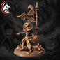 A Halloween-themed miniature figurine of a skeleton in a scythe standing beside a 'Cemetery' signpost with a crow on top, set against a dark spooky forest background with jack-o'-lanterns.