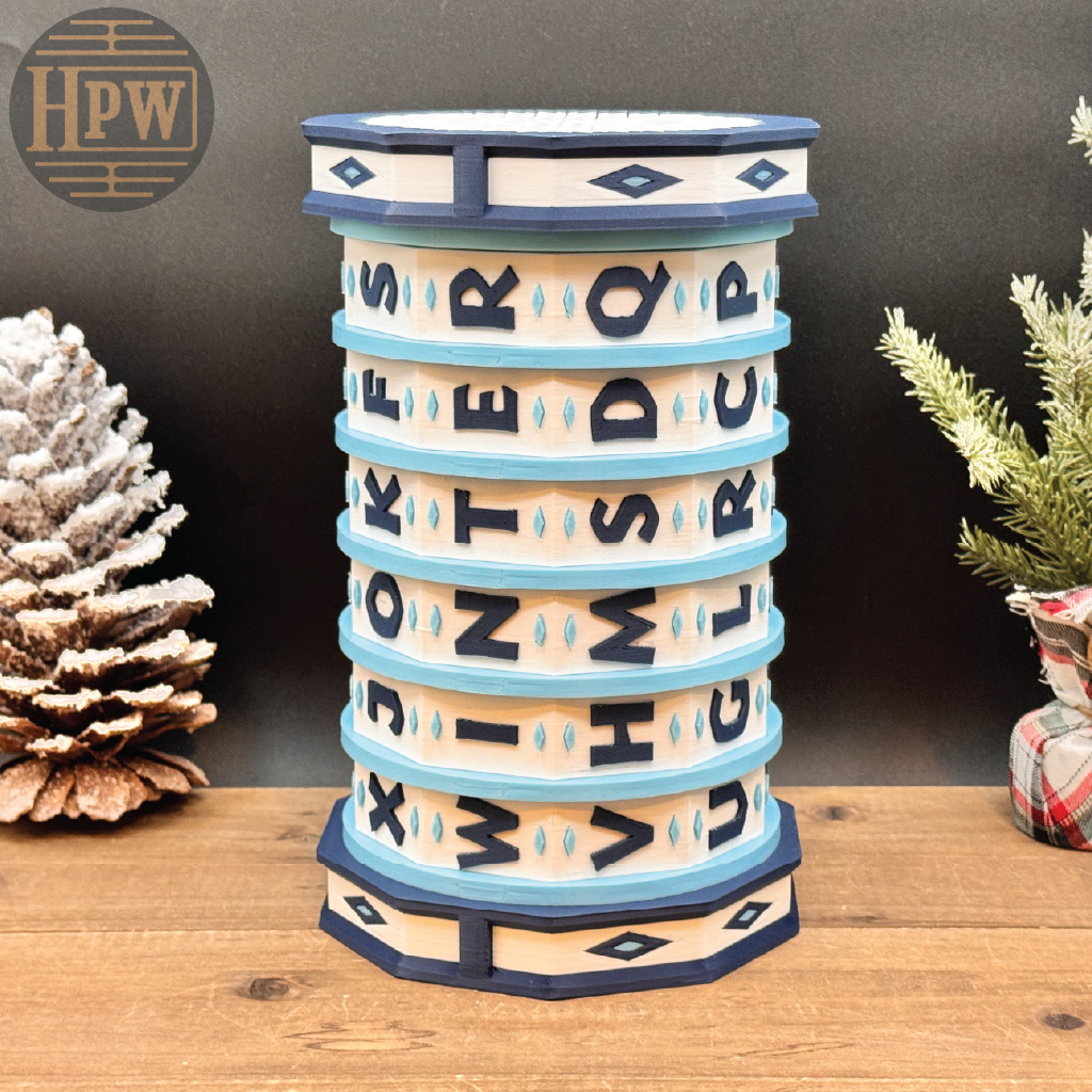 Decorative puzzle box with letter patterns on a wooden surface